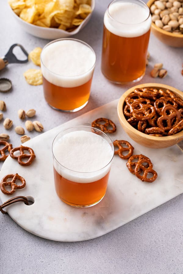 Traditional Lager Beer in Variety of Glasses with Snacks on the Table
