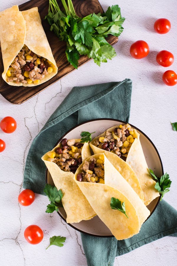 Traditional Mexican Burritos with Minced Meat, Corn and Beans on a
