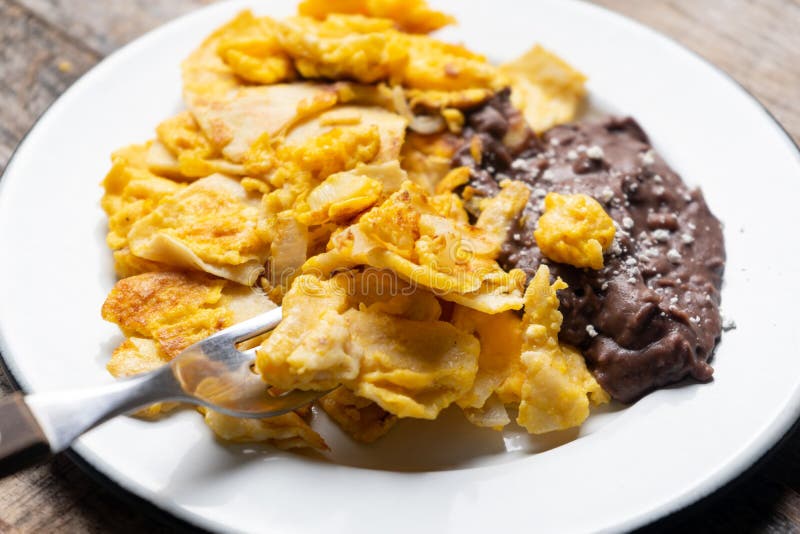 Mexican Scrambled Eggs with Corn Tortilla Also Called Migas on Wooden