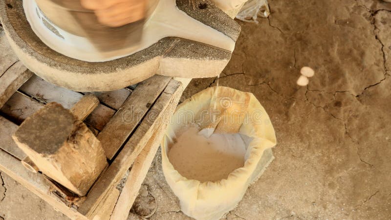 Upper view on hand-turned millstone in use for making soaked rice flour