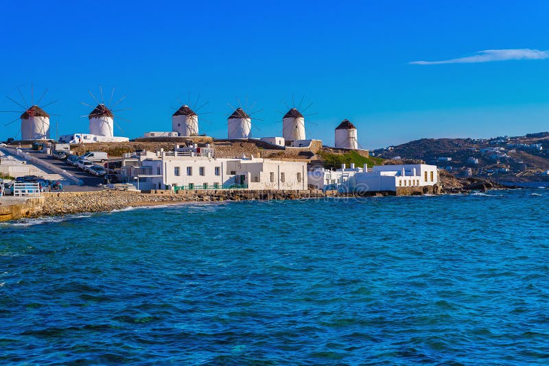 Traditional Mykonos windmill against a blue sky above the sea