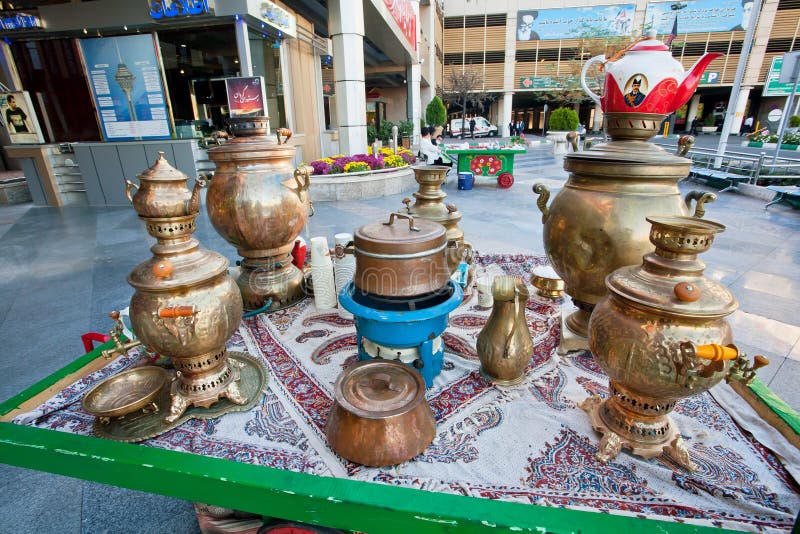 Traditional oriental old metal Samavar for tea drinking and teapots of outdoor cafe.