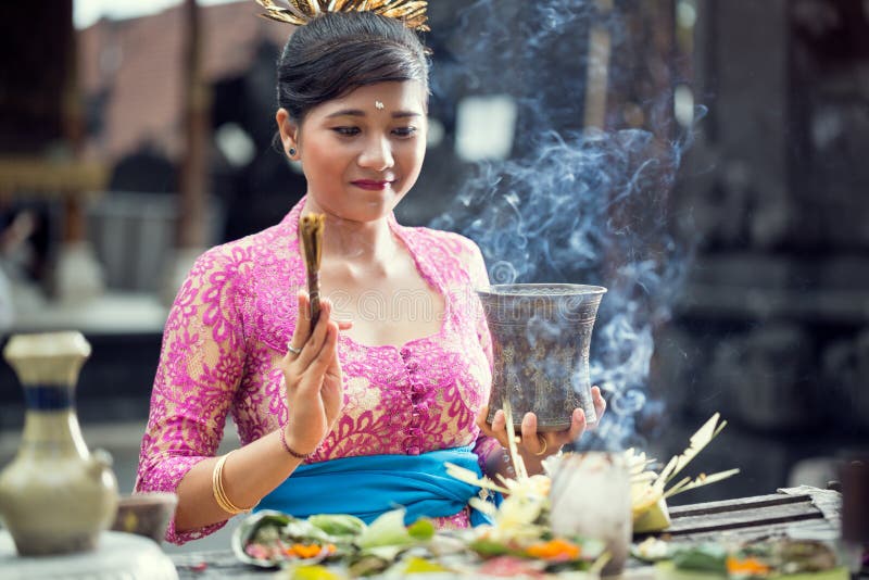 Traditional scene of Balinese women praying with offering for Gods. Traditional scene of Balinese woman praying with offering for Gods at the Hindu Temple stock photo Traditional scene of Balinese women praying with offering for Gods. Traditional scene of Balinese woman praying with offering for Gods at the Hindu Temple stock photo
