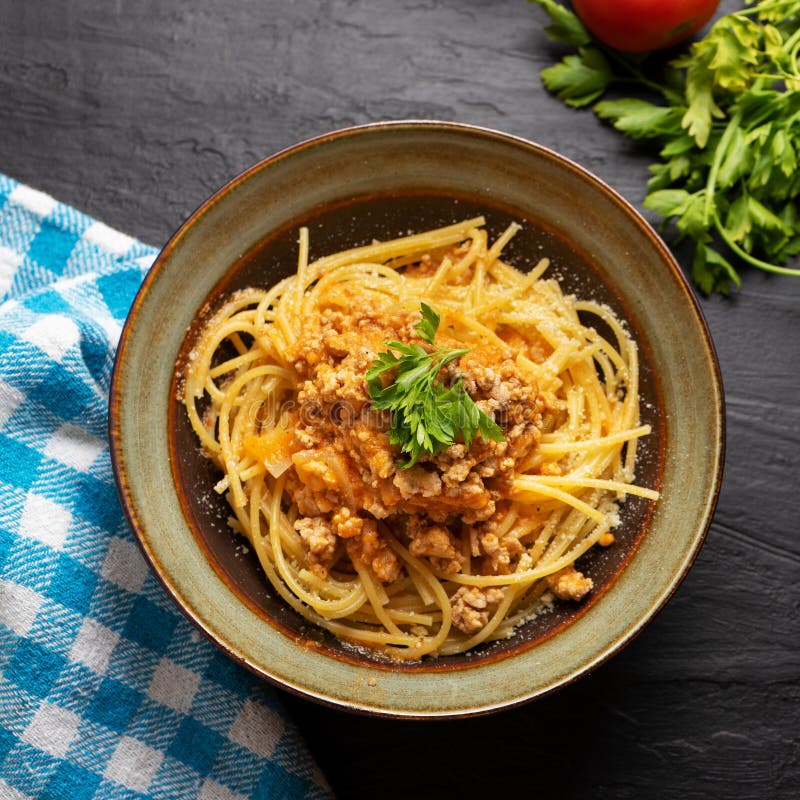 Spaghetti Bolognese with Parmesan Cheese on Dark Background Stock Photo