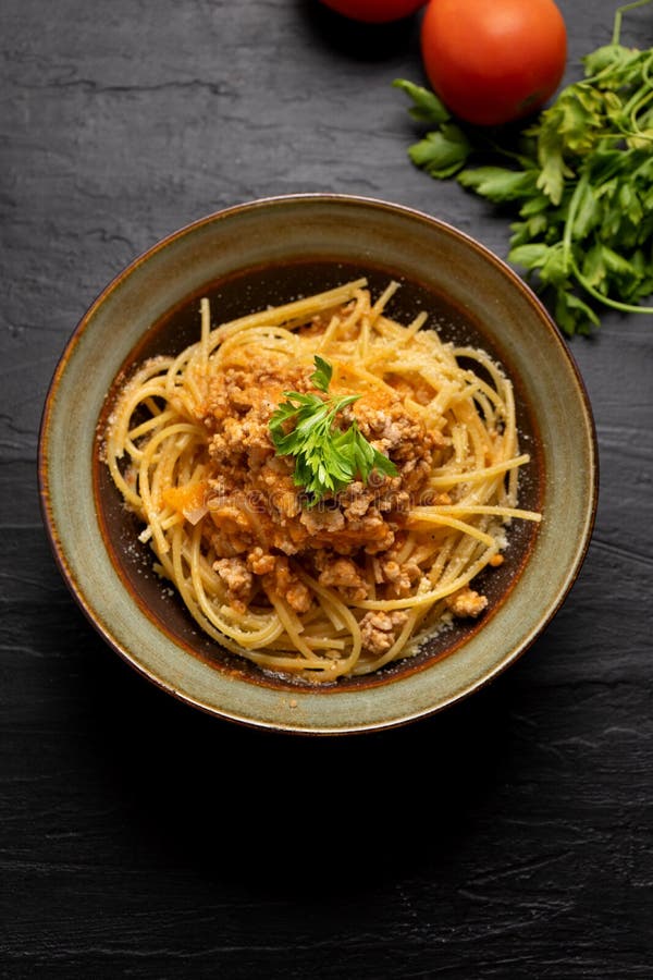 Spaghetti Bolognese with Parmesan Cheese on Dark Background Stock Image
