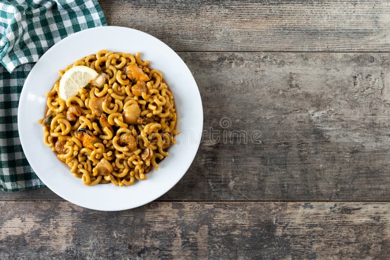 Traditional Spanish fideua. Noodle paella isolated on white background. Top  view Stock Photo - Alamy