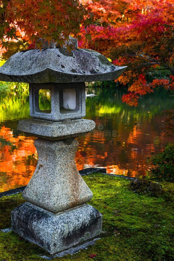 Traditional stone lantern and red maples in a Japanese garden during autumn royalty free stock images Traditional stone lantern and red maples in a Japanese garden during autumn royalty free stock images