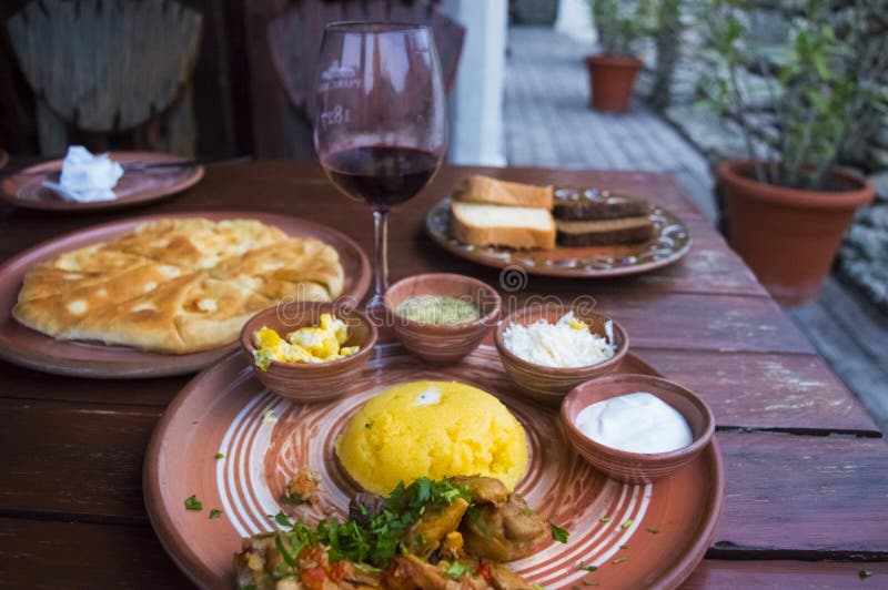 Traditional-style food set with mamalyga and a glass of wine and related ingredients stock image Traditional-style food set with mamalyga and a glass of wine and related ingredients stock image