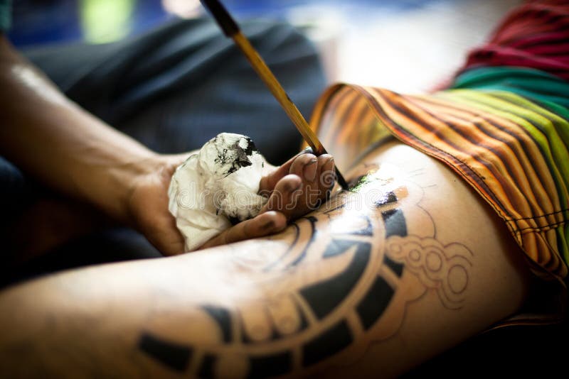 Unidentified master makes traditional tattoo bamboo, Dec 24, 2012 in Chang, Thailand. Thai tattooists are very popular among tourists, prices range from 500 thai baht and up.