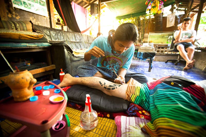 Unidentified master makes traditional tattoo bamboo, Dec 24, 2012 in Chang, Thailand. Thai tattooists are very popular among tourists, prices range from 500 thai baht and up.