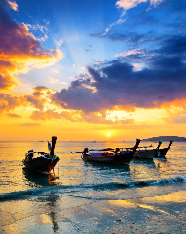 Traditional thai boats at sunset beach