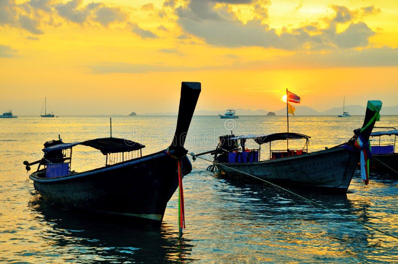 Traditional thai boats at sunset beach