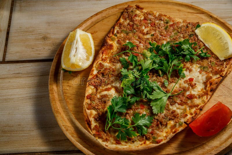 Traditional Turkish food Lahmajun on a wooden tray. stock photo Traditional Turkish food Lahmajun on a wooden tray. stock photo