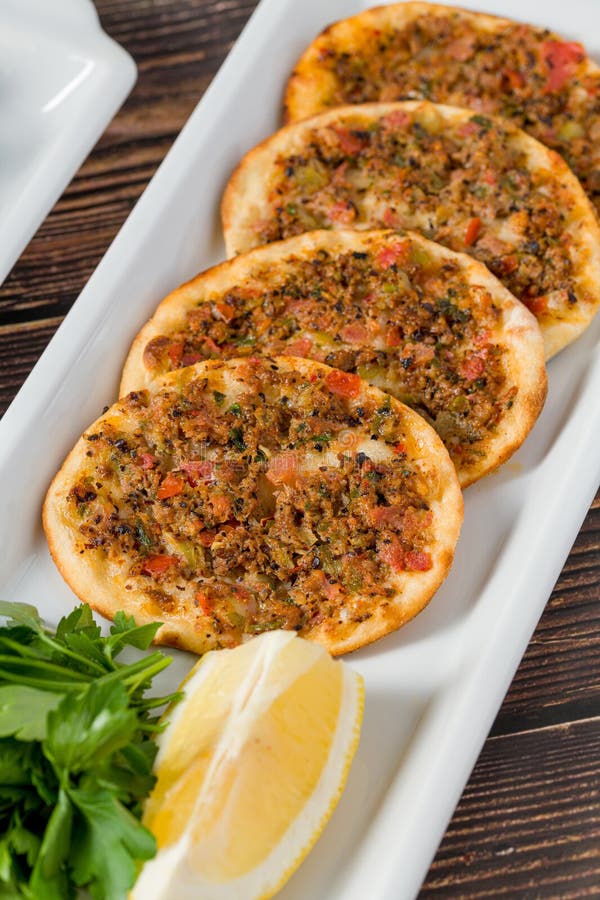 Traditional Turkish lahmacun served with lemon and parsley stock photos