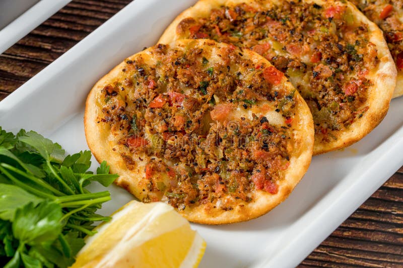 Traditional Turkish lahmacun served with lemon and parsley royalty free stock photo