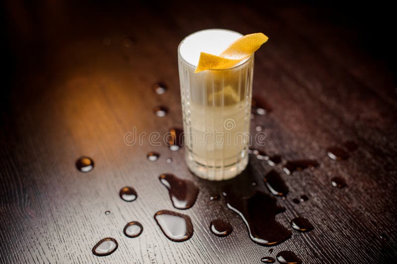 Traditional Whiskey Sour in a Rocks Glass with Orange Wheel with Egg White Froth stock image Traditional Whiskey Sour in a Rocks Glass with Orange Wheel with Egg White Froth stock image