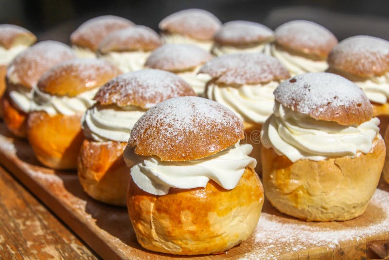 Traditional winter Scandinavian sweet: Semla or semlor, flavored with cardamom, filled with almond paste & whipped cream stock photos Traditional winter Scandinavian sweet: Semla or semlor, flavored with cardamom, filled with almond paste & whipped cream stock photos