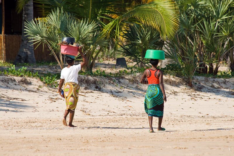 Traditional women walk with bowls on their heads stock image Traditional women walk with bowls on their heads stock image