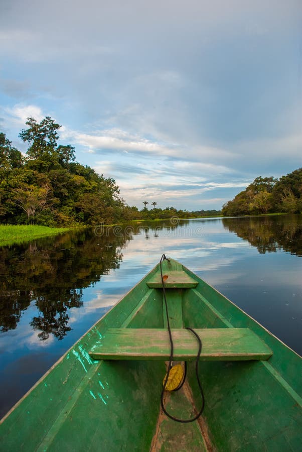 Traditional wooden boat floats on the Amazon river in the jungle. Amazon River Manaus, Amazonas, Brazil