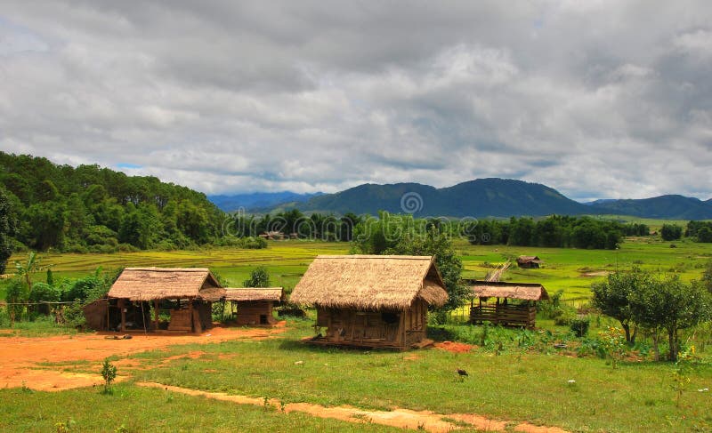 Traditional rural house surrounded by paddy fields and mountains. Northern Laos. Traditional rural house surrounded by paddy fields and mountains. Northern Laos.