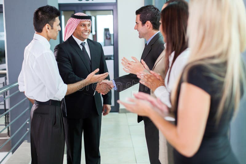 Translator introducing Arabian businessman to business partners. Translator introducing Arabian businessman to business partners