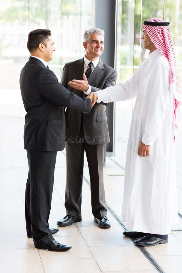 Senior translator introducing muslim businessman to business partner. Senior translator introducing muslim businessman to business partner