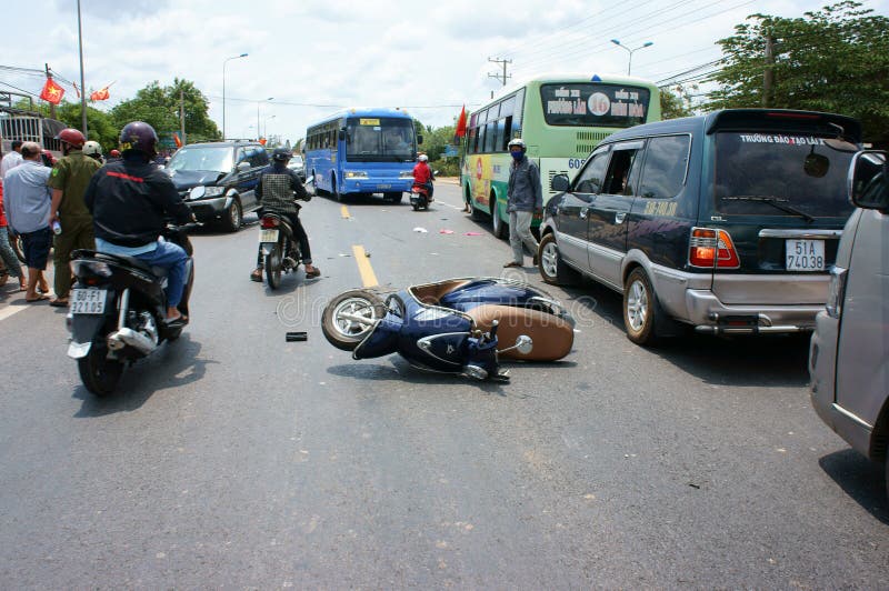 NAI, VIET NAM- MAY 1: Traffic accident on highway 20, crowded of Vietnamese people on street, car crash with motorbike, crashed car, motorcycle lay on street, unsafe traffic, Vietnam, May 1, 2015. NAI, VIET NAM- MAY 1: Traffic accident on highway 20, crowded of Vietnamese people on street, car crash with motorbike, crashed car, motorcycle lay on street, unsafe traffic, Vietnam, May 1, 2015