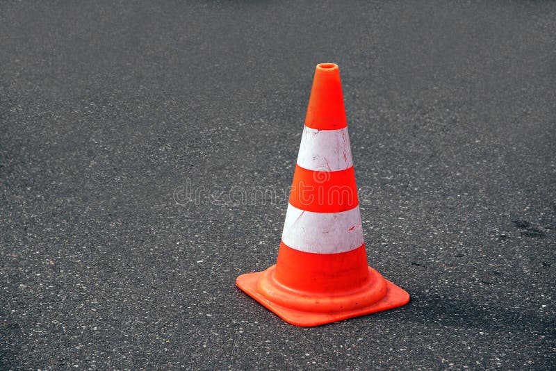 Traffic cone, white and orange on gray asphalt, copy space stock photography Traffic cone, white and orange on gray asphalt, copy space stock photography