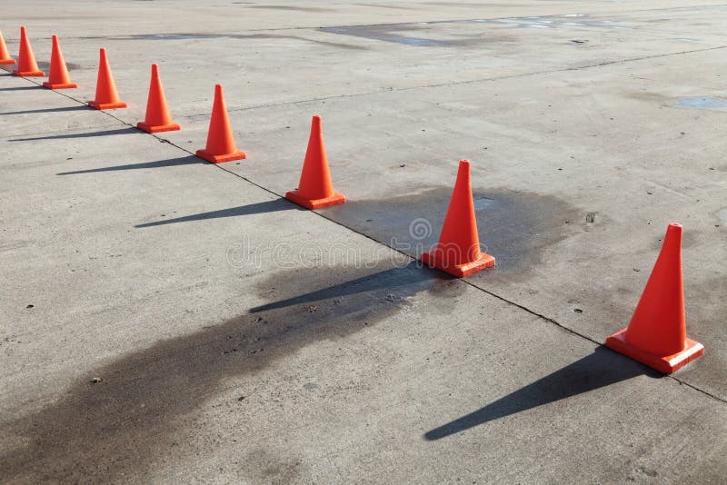 A row of orange traffic cones set on the road. Red pylons stock images, royalty-free photos and pictures