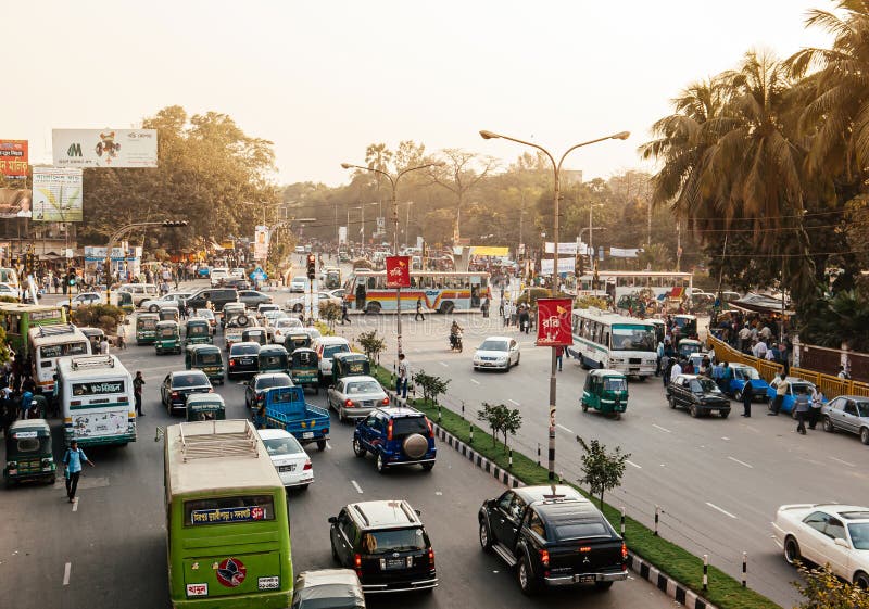 Traffic jam with many cars and buses on Dhaka city street with smoke and pollution. Bangladesh