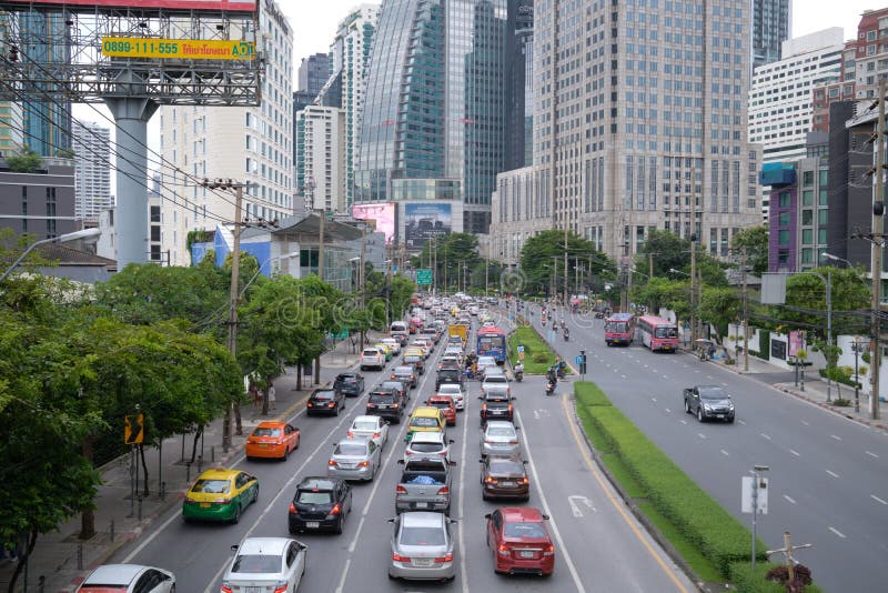 BANGKOK, THAILAND - OCT 9, 2022 : Traffic jam at Ratchadaphisek road near Asok junction. Asoke Intersection has high office building, hotel, shopping mall, shop, and Benjakitti park.