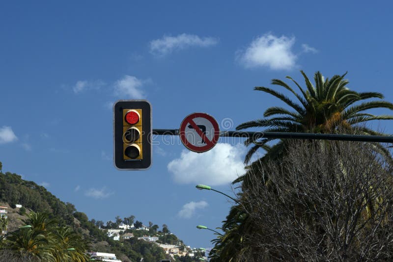 Traffic light against the blue sky. Red color of the traffic light. Turning left is prohibited. stock image Traffic light against the blue sky. Red color of the traffic light. Turning left is prohibited. stock image