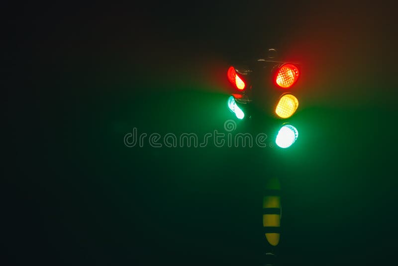 Traffic Lights, Pedestrian Green Light and Sign at Night Stock Photo