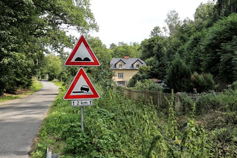 Dangerous turns, triangle warning traffic sign near rural road Stock Photo  - Alamy