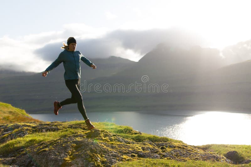 Trail runner running at the Faroe Islands above the fjord