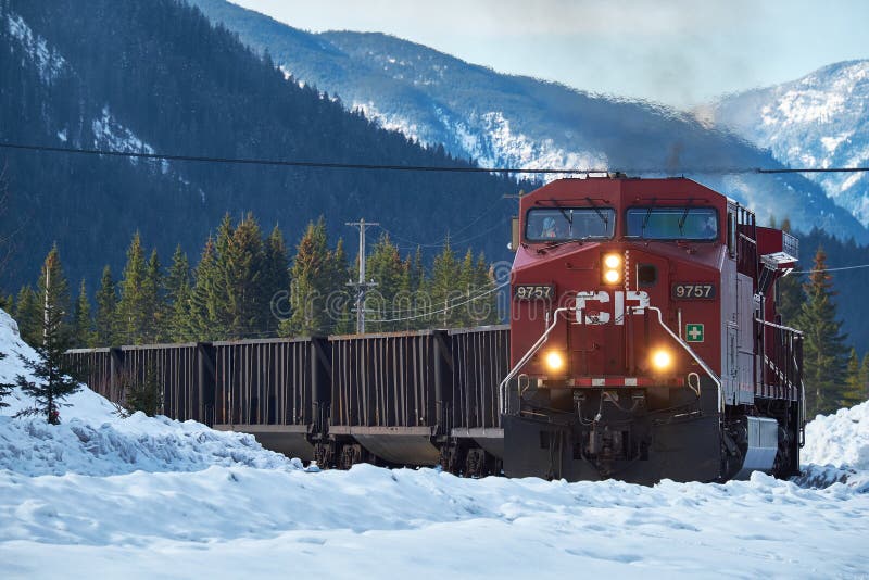 Train coming round the bend with Canadian Rockies in winter