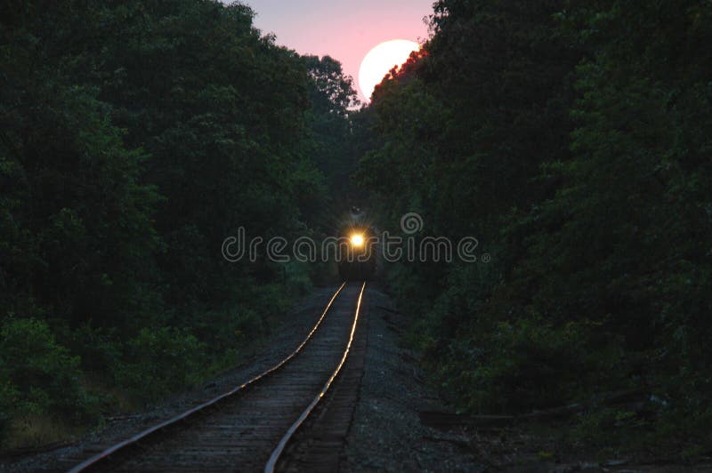 Train coming from setting sun