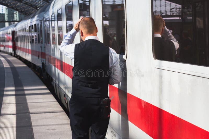 Train conductor from behind standing at station in front of train royalty free stock photos Train conductor from behind standing at station in front of train royalty free stock photos