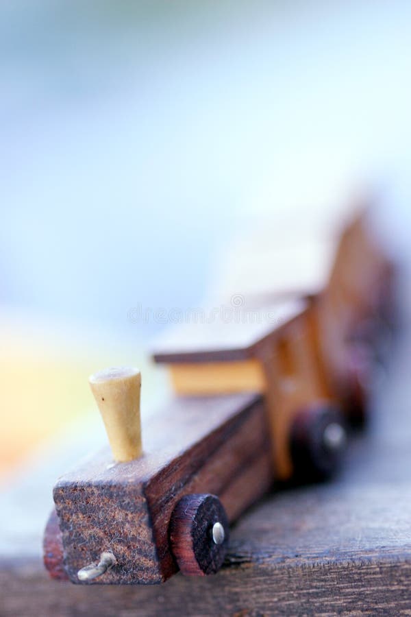 Small wooden toy train: focus on the front part, rest out of focus. Small wooden toy train: focus on the front part, rest out of focus.