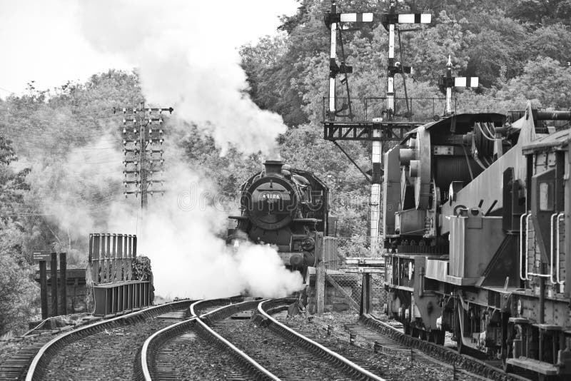 Vintage old steam train on rail tracks in black and white. Vintage old steam train on rail tracks in black and white.