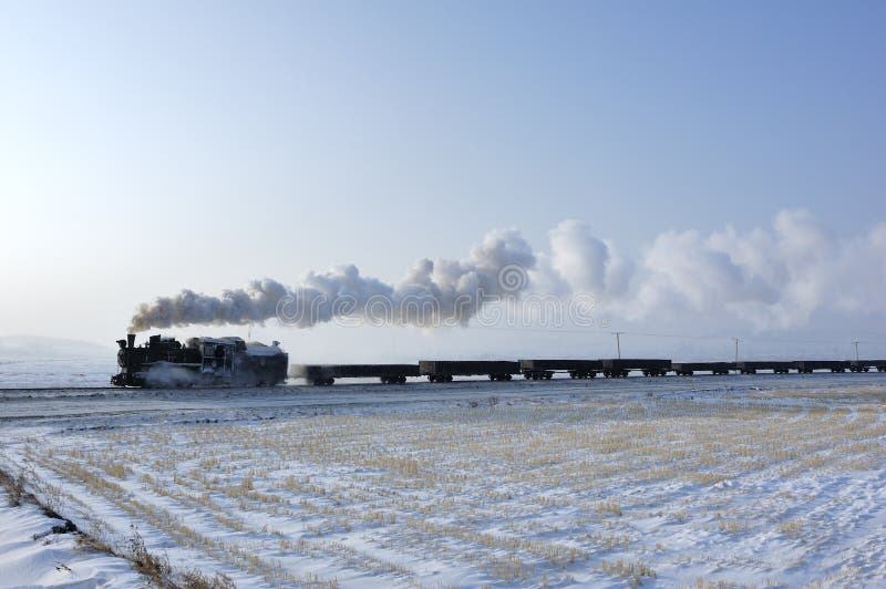 Winter in the fields of running a steam train. Winter in the fields of running a steam train
