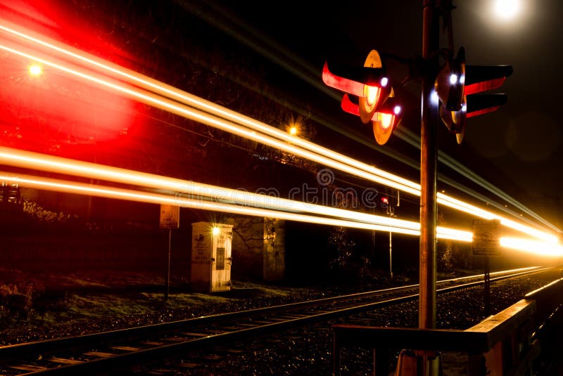 Train travelling through crossing at night. Night train stock images, royalty-free photos and pictures