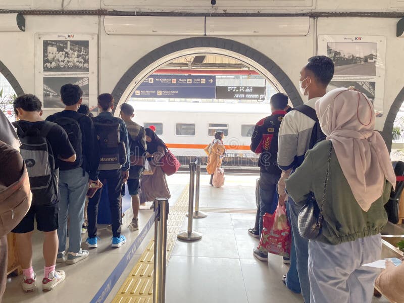 Train passengers queue to enter the train departure platform