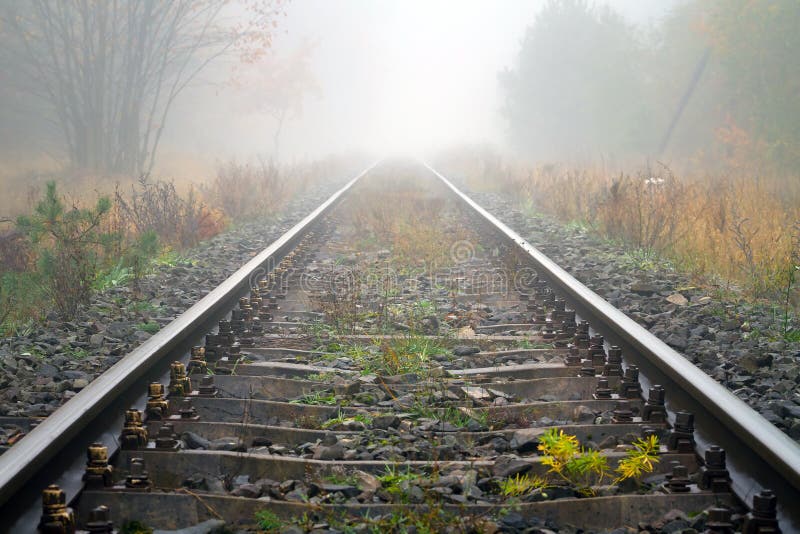 Train rails in foggy weather stock photos