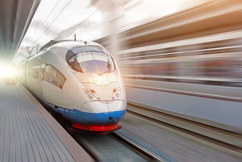 Train rides at high speed at the railway station in the city