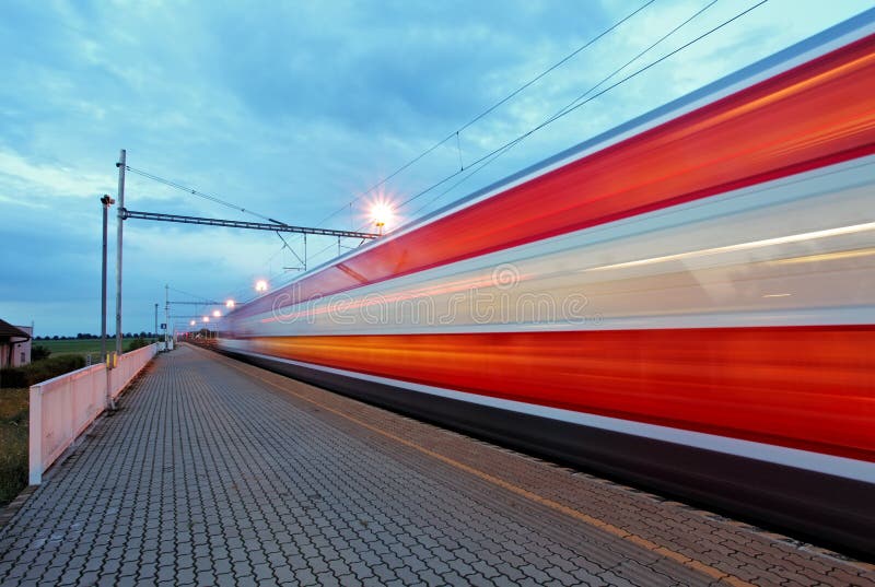 Train station in motion blur at night, railroad