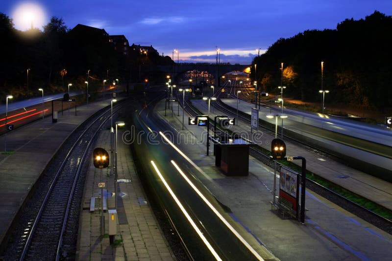 Train station at night, with trains going past. Night train stock images, royalty-free photos and pictures