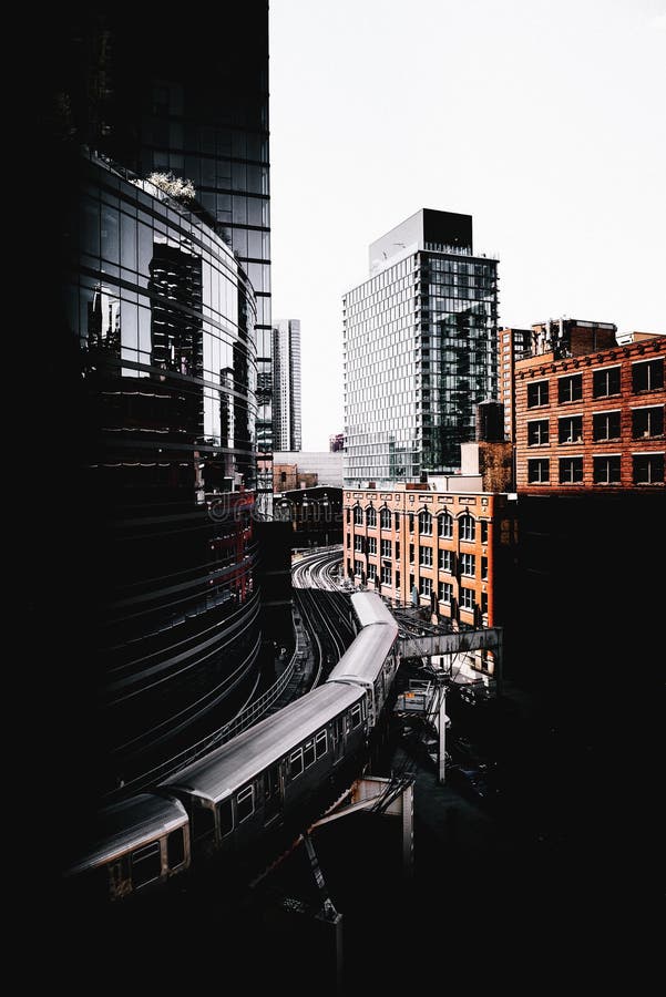 Train turning between business buildings stock photography Train turning between business buildings stock photography