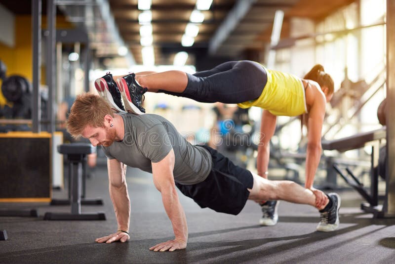 Young Fit Couple In Gym Lying On The Floor Resting Stock Image