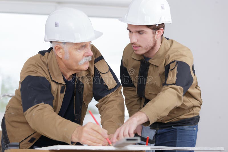 Trainee carpenter with mentor stock photography Trainee carpenter with mentor stock photography